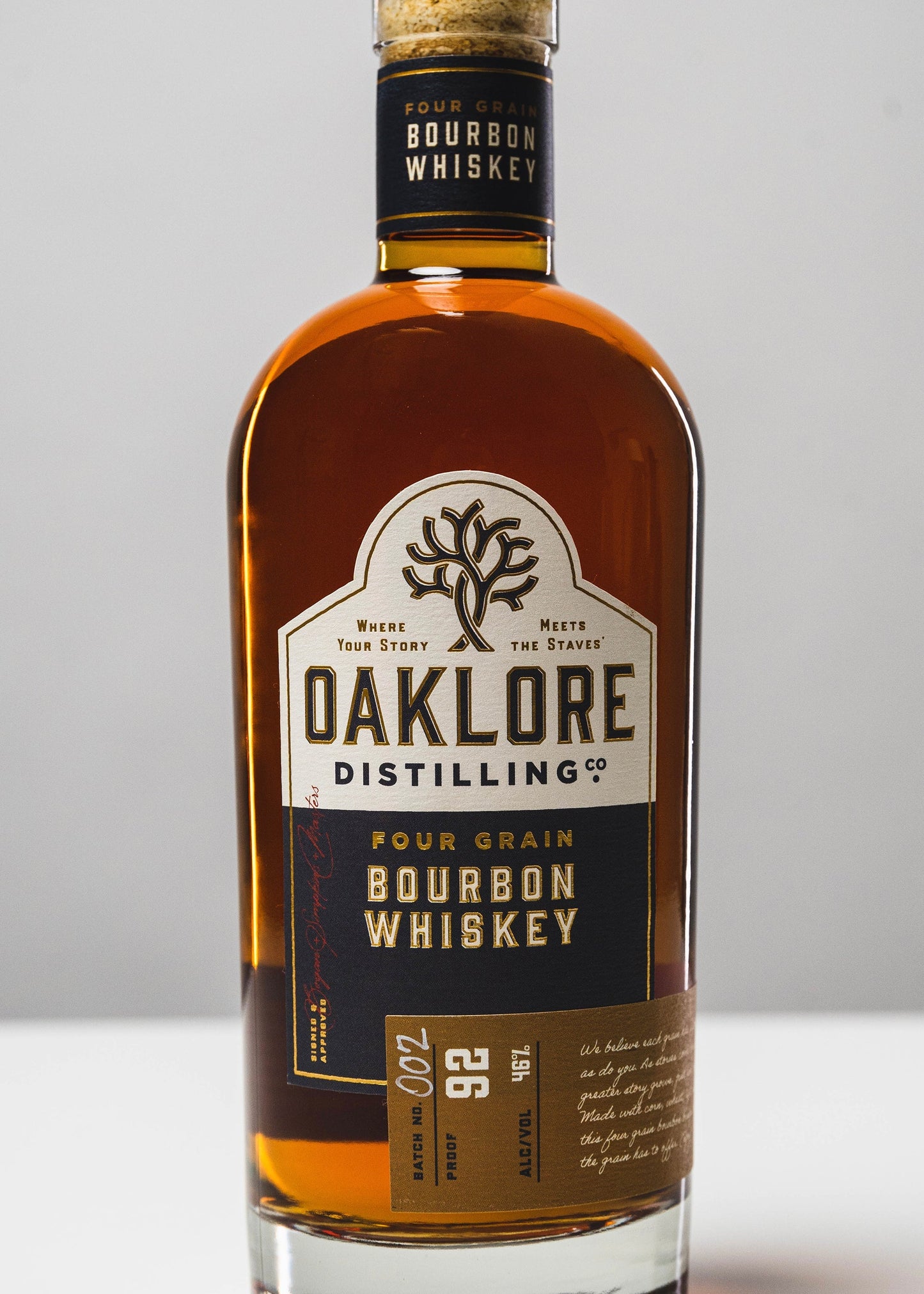 Bottle of Oaklore Distilling Co. bourbon whiskey on a gray background
