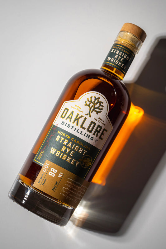 Oaklore Distilling Co. Straight Rye Whiskey bottle laying down on a white backdrop